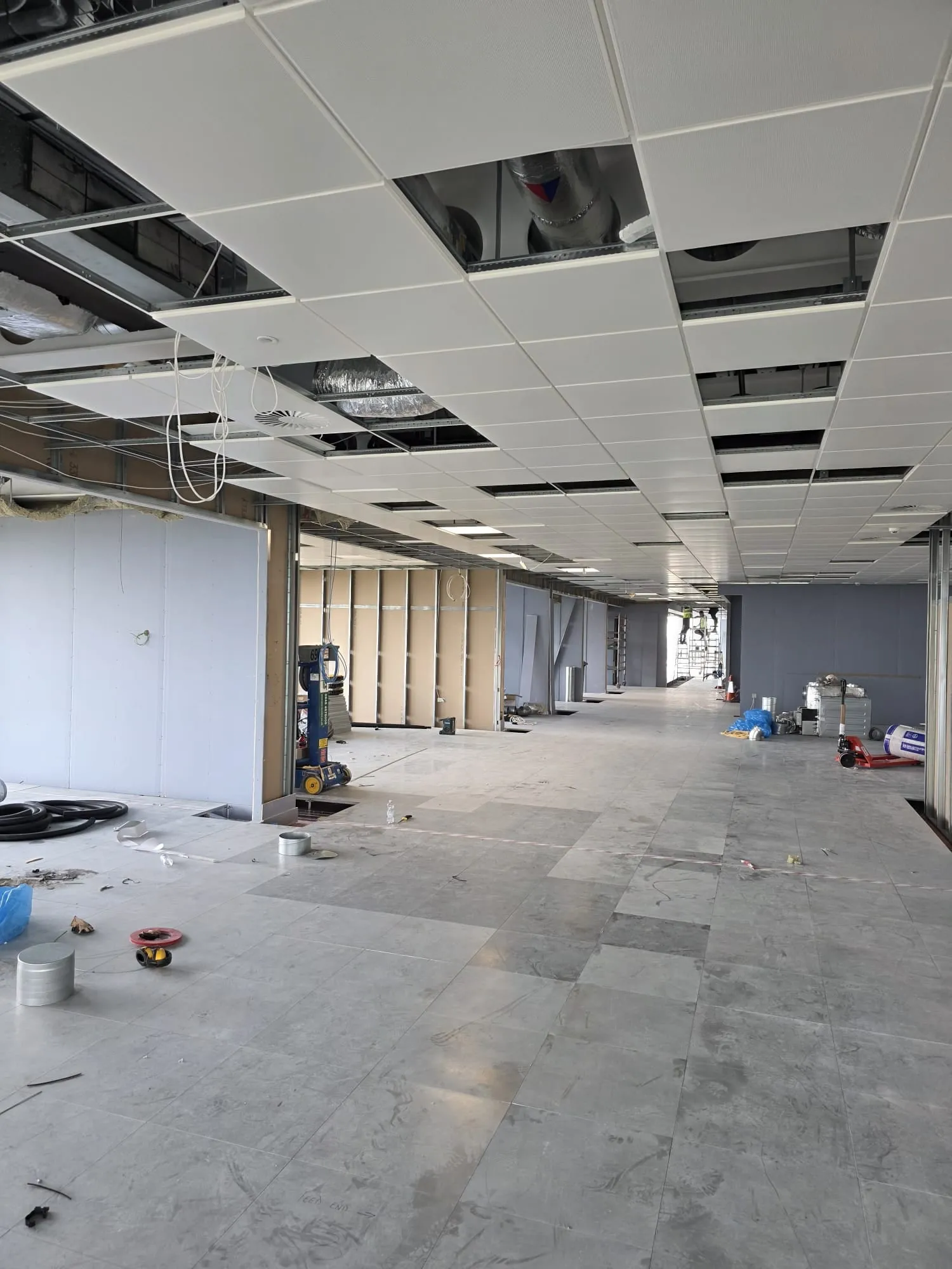 An open-plan office fit-out with new partitions and a suspended ceiling